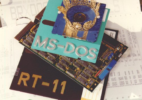 
 Symbolic still life of 
 an RT-11 floppy disk,
 the BAYDEL BRX50 board, 
 MS-DOS diskettes and
 a tiny crown 
 (50 Kbytes JPEG)
 Photo: MOSESelectronic
